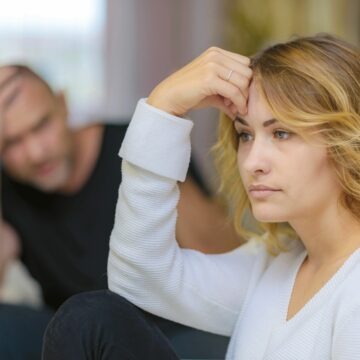 Family problems of the young wife and husband on the sofa in a room. fot. depositphotos