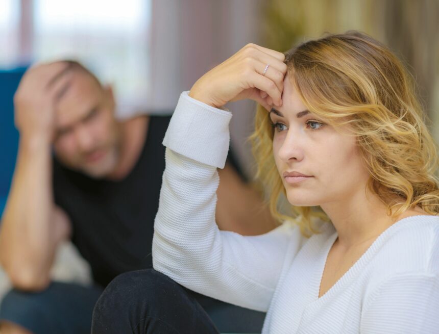 Family problems of the young wife and husband on the sofa in a room. fot. depositphotos